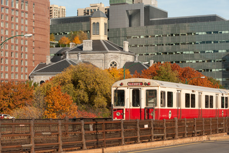 Red line subway train of MBTA with Boston on background