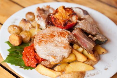 Plate with grilled meat and chicken in local Croatian restaurantの写真素材
