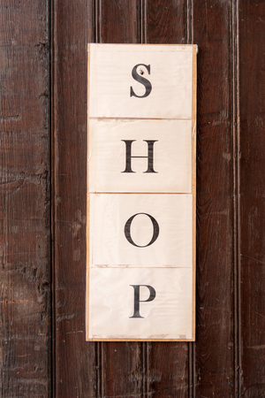 Shop sign on shopping street in downtown Bruges, Belgiumの写真素材