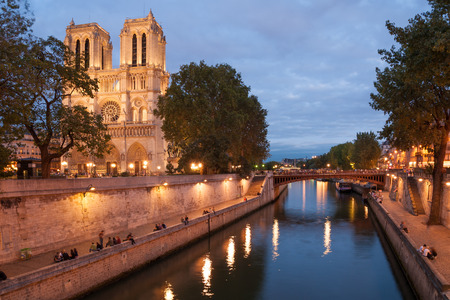 Notre Dame de Paris and Seine embankment in summer eveningの写真素材