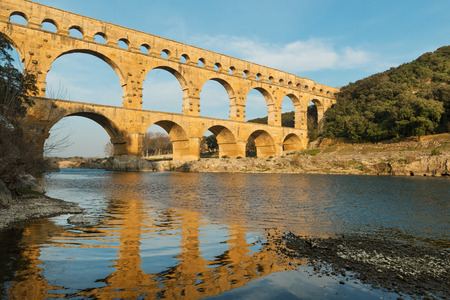 Famous Pont Du Gard reflecting in Gardon river in Southern Franceの写真素材
