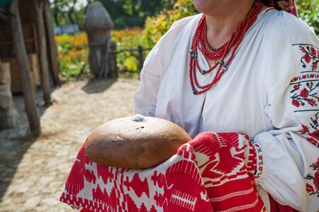Traditional Eastern Slavic welcome with loaf of bread and salt in Ukraineの写真素材