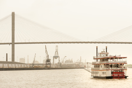 Paddle-wheeler cruising towards Talmadge Memorial bridge and Port of  Savannah, GAの写真素材