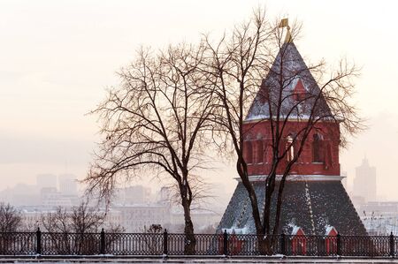 Taynitskaya Tower of Moscow Kremlin and city view at winter sunsetの写真素材