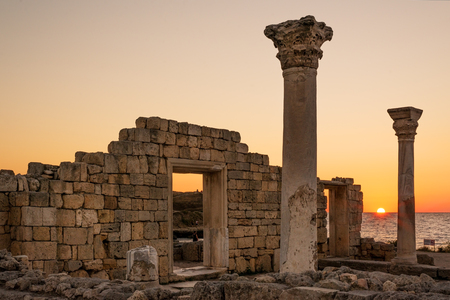 Sun setting by ancient basilica columns of Creek colony Chersonesos in Sevastopol, Crimeaの写真素材