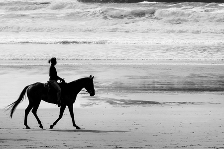 Horseback riding on Cannon beach, Oregon coast, USAの写真素材
