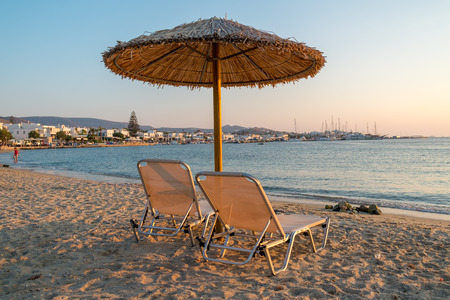 Pair of sunbeds on sandy beach in Parikia, Paros island, Greeceの写真素材