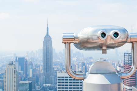 Binoculars on the observation platform with midtown and downtown Manhattan skylineの写真素材