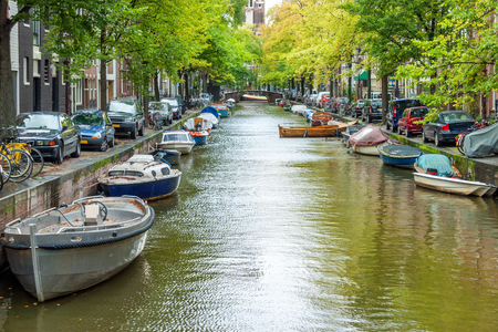 Typical houseboats along the canal in downtown Amsterdamの写真素材