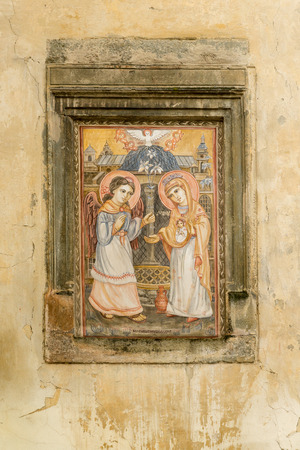 Old house wall adorned with painted icon in historic part of Lviv near Market Square, Ukraineのeditorial素材