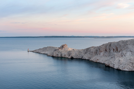 Ruins of old fortress and small lighthouse on Pag island, Croatiaの写真素材