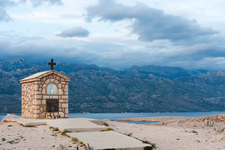 Small chapel dedicated to Saint Mary on the island of Pag with Velebit mountains on background, Croatiaの写真素材