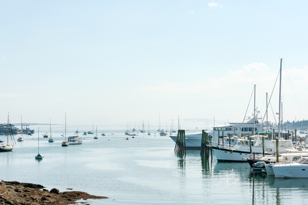 Upscale yachts and small fishing boats in the marina of touristic Southwest Harbor, Mount Desert island, Maine coast, USAの写真素材