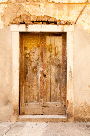 Aged shabby wooden door of the typical old building in Zadar, Croatiaの写真素材