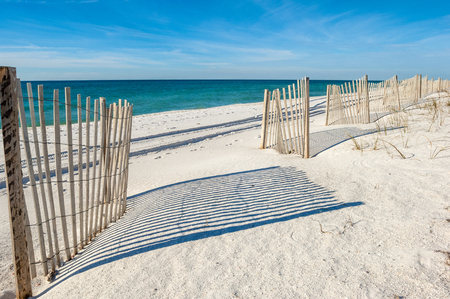 Empty white sandy beach with fences,  Gulf of Mexico coast, Alabama, USAの写真素材