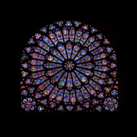 Rose window stained glass of famous Notre Dame de Paris cathedral in Paris, France
