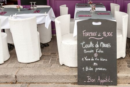 Menu display with mussels specials along outside tables in Honfleur seafood restaurant, Normandy, Franceの写真素材