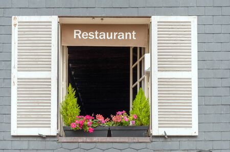 Cozy French restaurant window of typical house in oceanside village, Normandy, Franceの写真素材