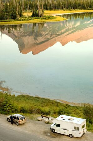 Rest stop by the lake reflecting forest and mountains in Banff national park, Rocky Mountains, Canadaの写真素材