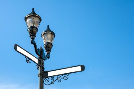 Antique iron streetlight with blank street names on the crossroads in Hoboken, New Jersey, USAの写真素材