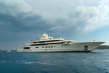 Luxury super yacht passing Korcula island in Adriatic, Croatiaの写真素材