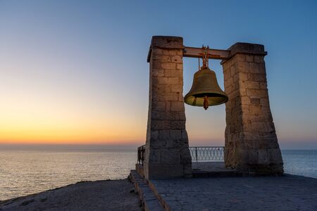 Famous Bell of Chersonesos (sygnal fog bell) on the grounds of ancient Greek colony Chersonesos by Black sea at sunset, Crimeaの写真素材
