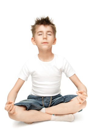Relaxed child practicing yoga isolated on white backgroundの写真素材