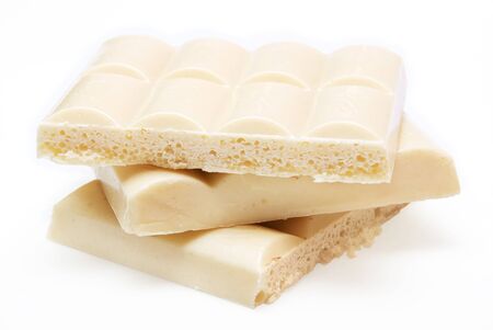 slices of  white aerated chocolate isolated on white backgroundの写真素材