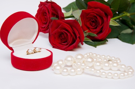 bouquet of red roses with pearl necklaces and earringsの写真素材