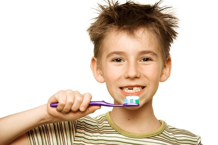 Beautiful boy brushing teeth, isolated on whiteの写真素材