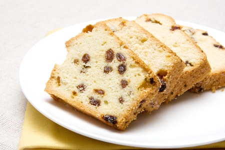 slices of cake with raisins arranged on a white plateの写真素材