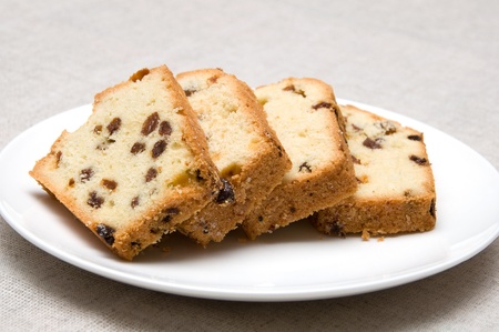 slices of cake with raisins arranged on a white plateの写真素材