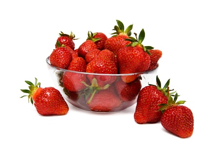 strawberries in a glass bowl isolated on a white background