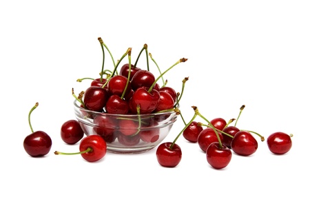 Fresh red cherry in a glass bowl isolated on a white backgroundの写真素材