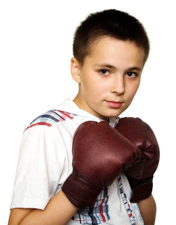 Young boy wearing brown boxing glovesの写真素材