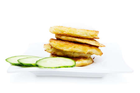 Traditional delicious potato pancakes served with sour cream isolated on white backgroundの写真素材