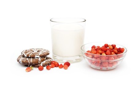 glass of milk, wild strawberries and cookies isolated on a white backgroundの写真素材