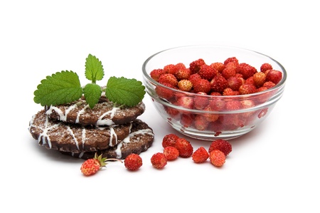 Wild strawberries and cookies isolated on a white backgroundの写真素材