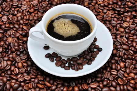 A cup of coffee with coffee bean as backgroundの写真素材