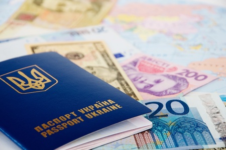 passport and money from different countries are on the world mapの写真素材