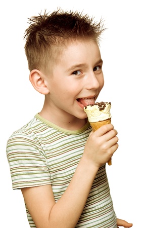 Eighth year boy eating ice cream isolated on whiteの写真素材