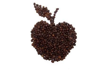 Coffee beans spread out in the form of a appleの写真素材
