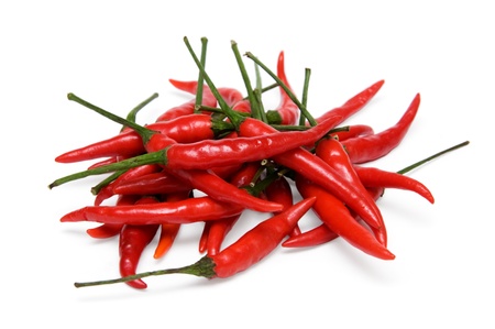 a bunch of red chili peppers isolated on a white backgroundの写真素材