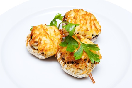 mushrooms stuffed with cheese on white plateの写真素材