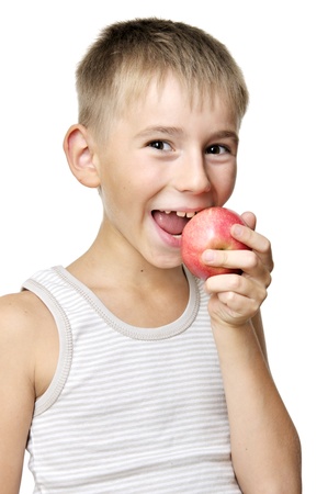 cute boy eating red apple isolated on a white backgroundの写真素材