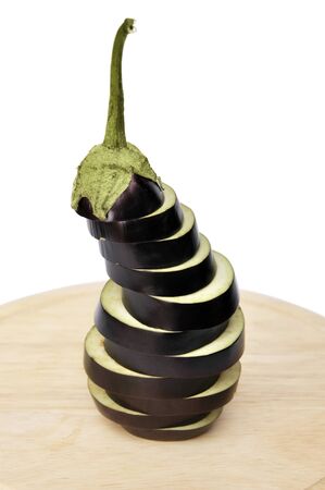 Sliced eggplant on wooden cutting boardの写真素材