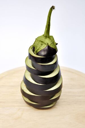 Sliced eggplant on wooden cutting boardの写真素材
