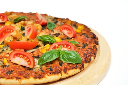 Pizza with ham and tomatoes on white backgroundの写真素材