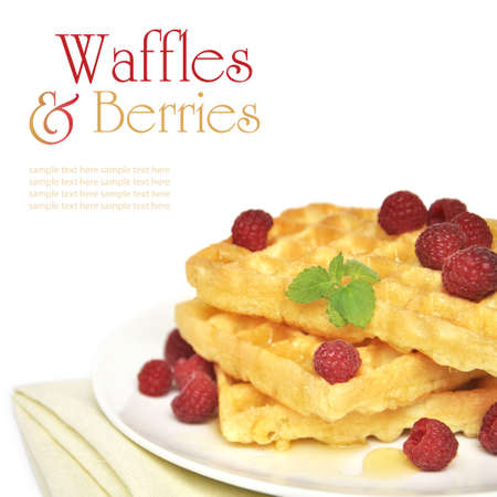 Waffles with honey and raspberry on white plateの写真素材