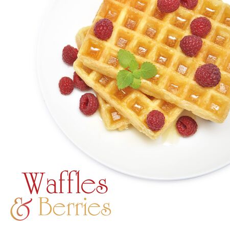 Waffles with honey and raspberry on white plate over white backgroundの写真素材